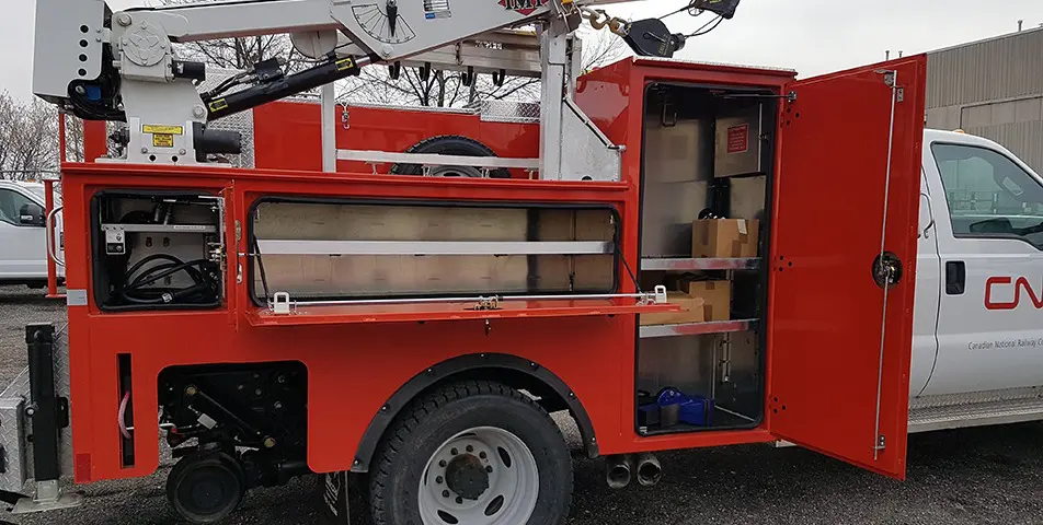 CN Rail On Track Truck Bodies with side storage compartments and hydraulic crane installation