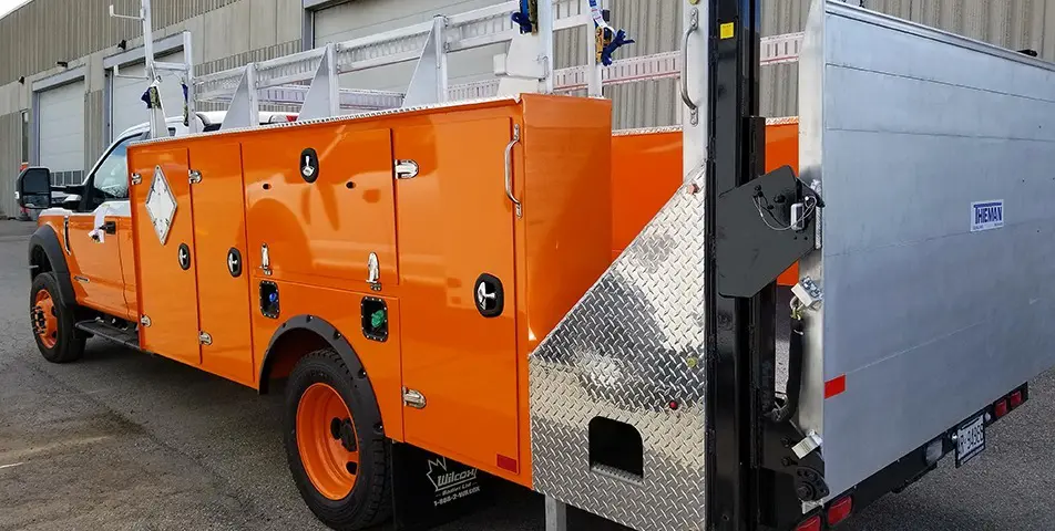 Orange Service Truck Bodies with Theman Hydraulic Liftgate with side panel storage compartments