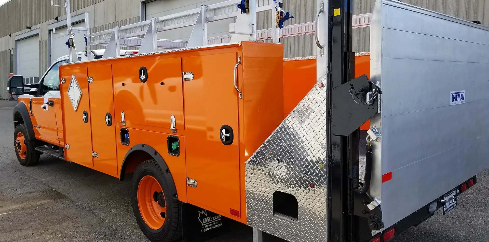 Orange Service Truck Bodies With Hydraulic liftgate and side storage compartments