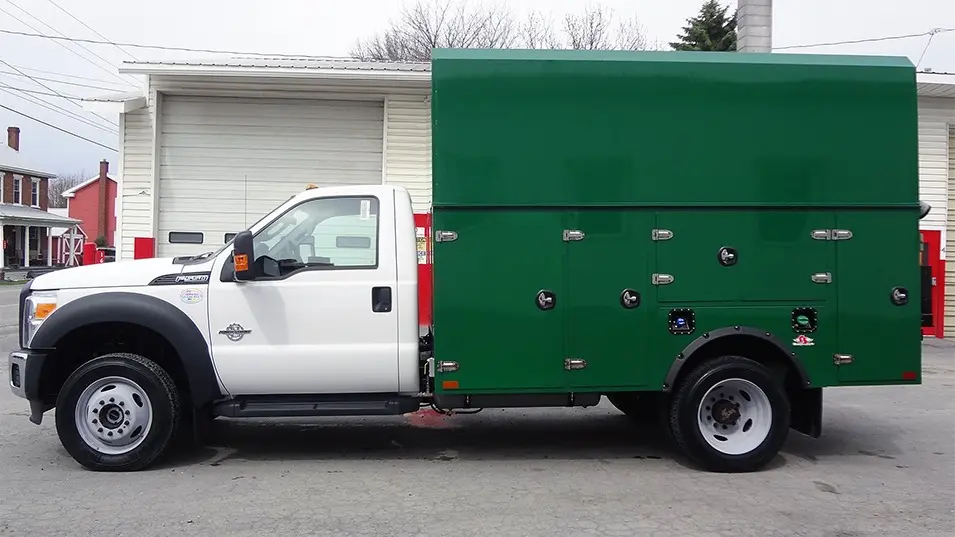 Green and White Service Truck Bodies with side storage cabinets