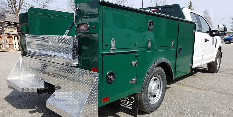 Green Service Truck Bodies - back view with back step and side storage panels